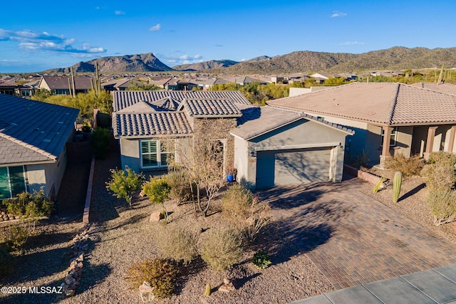 view of front of home featuring a mountain view and a garage