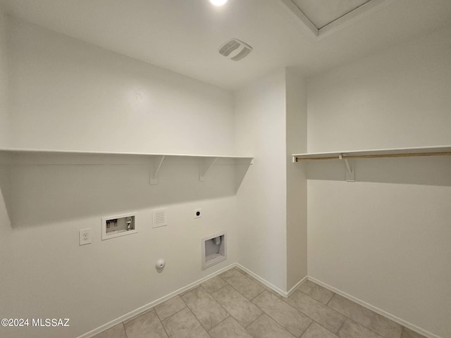 clothes washing area with hookup for a washing machine, gas dryer hookup, and hookup for an electric dryer