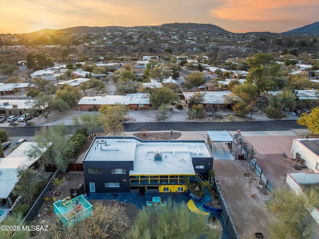 aerial view at dusk featuring a mountain view