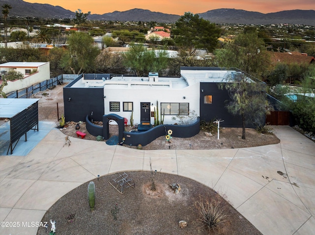 4502 N Twilight Trl, Tucson, AZ 85749 - view of front of house featuring a mountain view, stucco siding, and fence