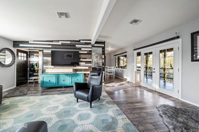 living room with vaulted ceiling with beams, dark hardwood / wood-style floors, and french doors