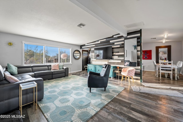 living room featuring lofted ceiling with beams and hardwood / wood-style floors