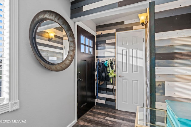 entrance foyer with dark hardwood / wood-style flooring and vaulted ceiling