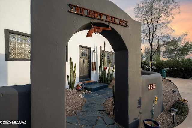 view of exterior entry at dusk