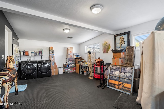 interior space featuring plenty of natural light, carpet flooring, washer and clothes dryer, and a textured ceiling