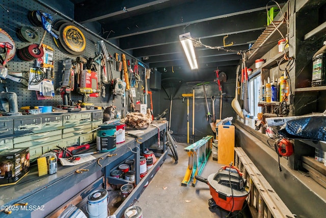 misc room with a workshop area and concrete floors