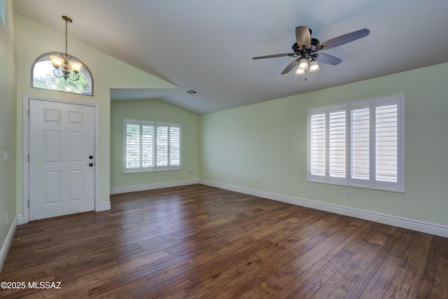 entrance foyer with vaulted ceiling, dark wood-type flooring, and ceiling fan with notable chandelier