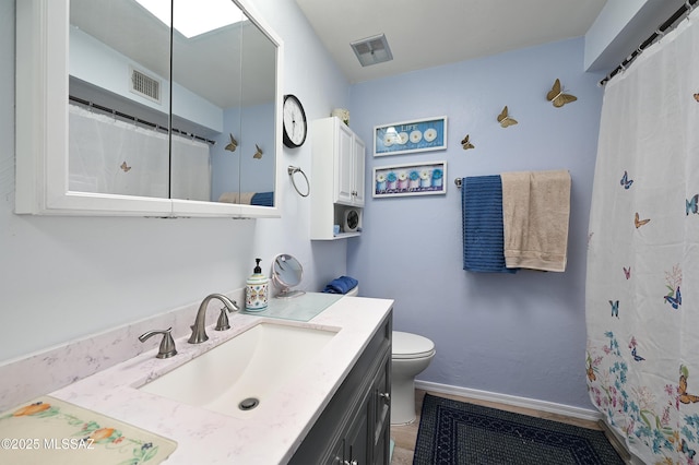 bathroom featuring vanity and toilet