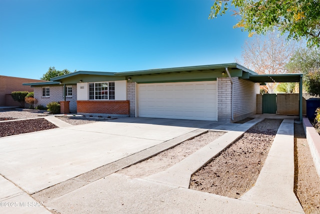 single story home featuring a carport and a garage