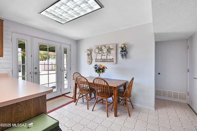 dining room featuring a textured ceiling