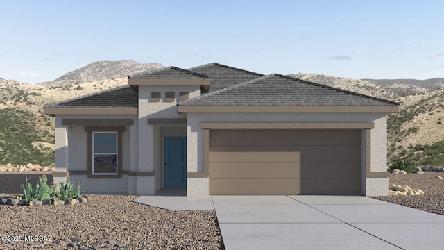 view of front of property featuring a mountain view and a garage