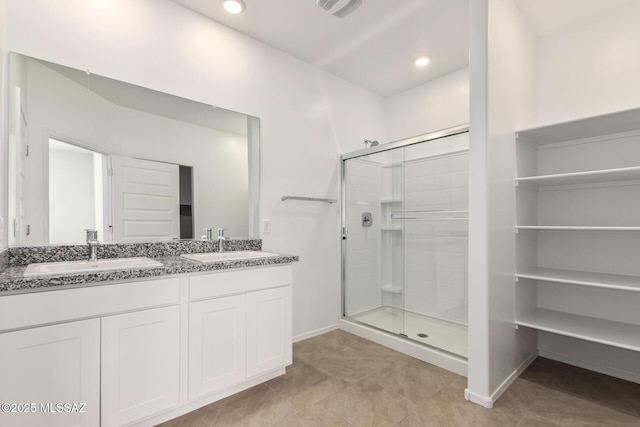 bathroom with vanity, tile patterned flooring, and a shower with shower door