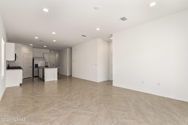 unfurnished living room with sink