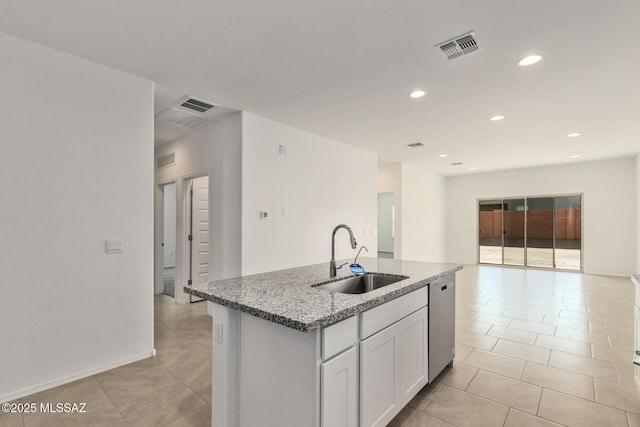 kitchen with sink, stone countertops, dishwasher, a kitchen island with sink, and white cabinets