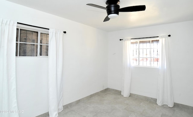 unfurnished room with ceiling fan