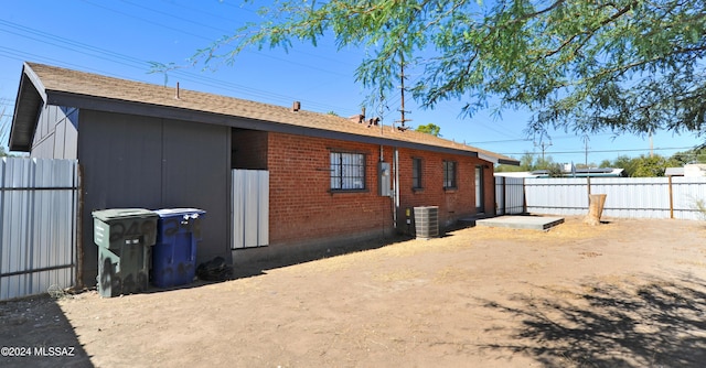 rear view of property featuring central AC unit