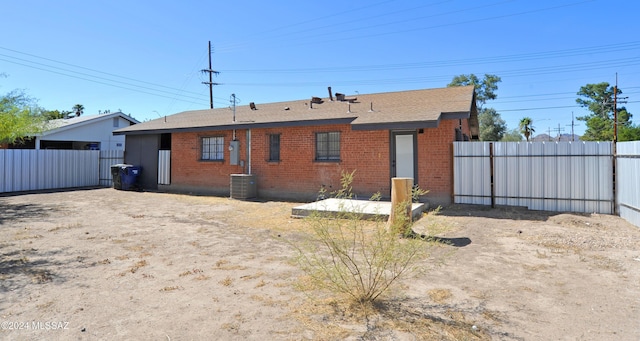 back of property featuring central AC