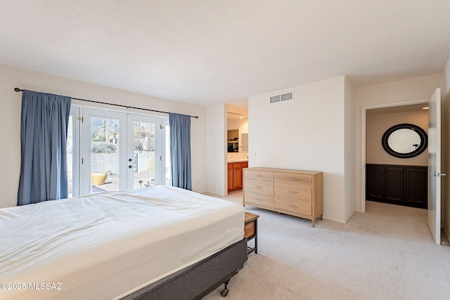 bedroom with access to outside, french doors, visible vents, and light colored carpet