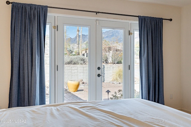 bedroom with access to exterior, french doors, and multiple windows