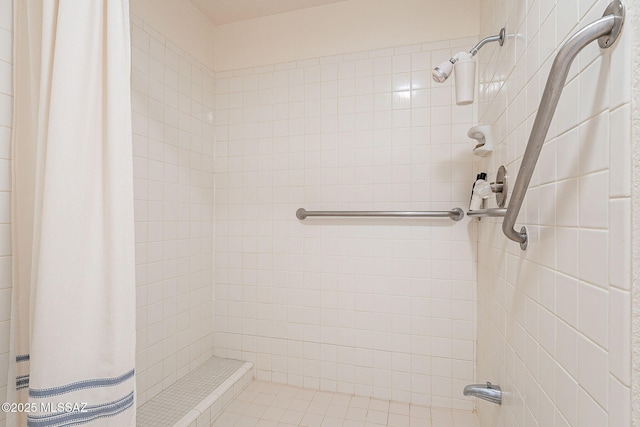 full bath with a tile shower