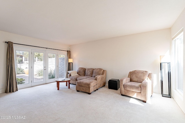 living room featuring french doors and light colored carpet