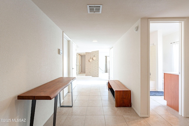 5658 N Calle De La Reina, Tucson, AZ 85718 - hallway with light tile patterned flooring and a textured wall