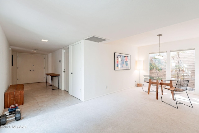 dining room with visible vents and light colored carpet