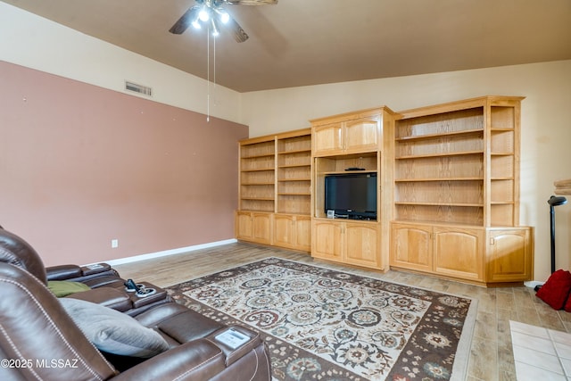living room featuring ceiling fan, lofted ceiling, and light hardwood / wood-style floors