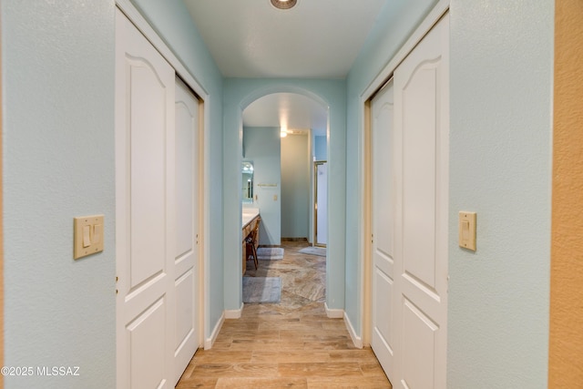 corridor with light hardwood / wood-style flooring
