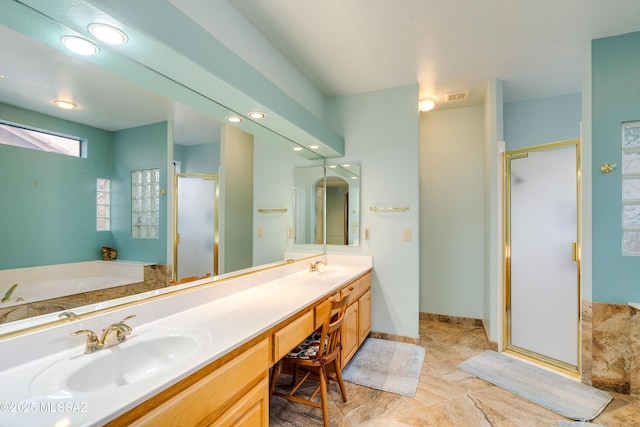 bathroom featuring independent shower and bath and vanity