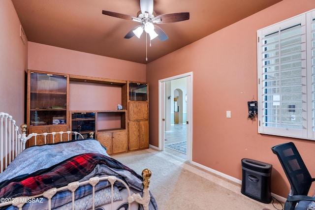 carpeted bedroom with radiator and ceiling fan