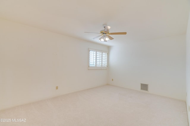 empty room with light colored carpet and ceiling fan