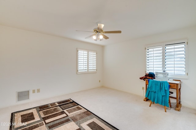 interior space with carpet and ceiling fan