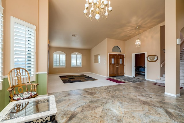 foyer featuring high vaulted ceiling and a notable chandelier
