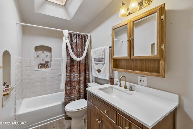 full bathroom with shower / tub combo with curtain, a skylight, wood-type flooring, vanity, and toilet