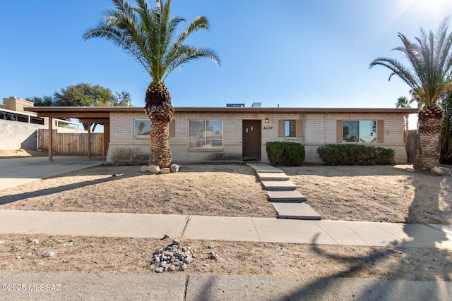 ranch-style home featuring a carport