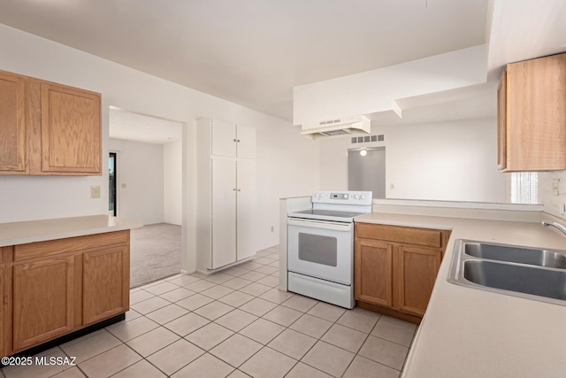 kitchen with light tile patterned flooring, white electric range, kitchen peninsula, and sink