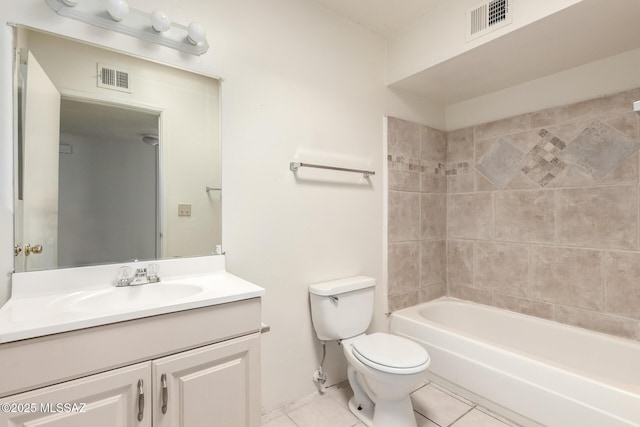 full bathroom with tiled shower / bath, tile patterned floors, toilet, and vanity