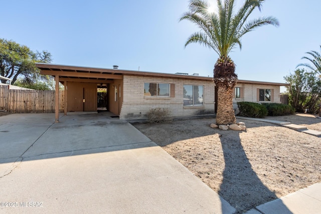 single story home featuring a carport