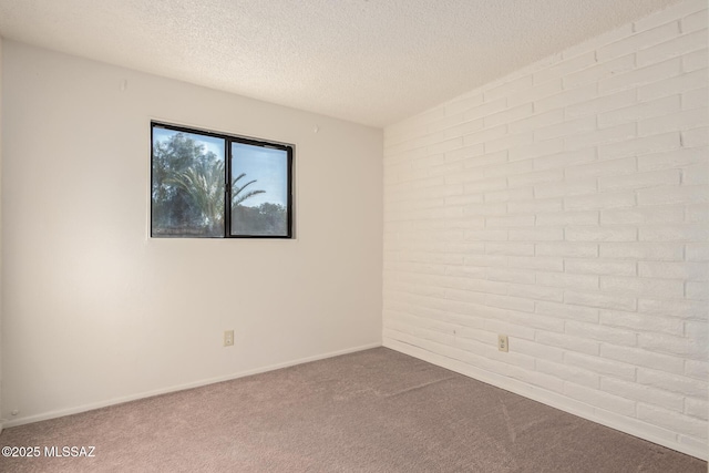 carpeted empty room with a textured ceiling