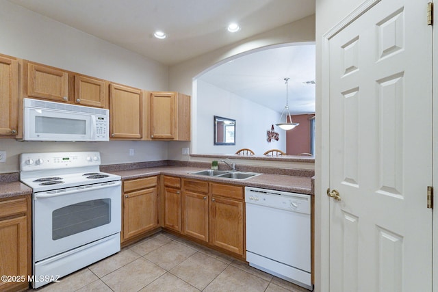 kitchen featuring light tile patterned floors, arched walkways, recessed lighting, white appliances, and a sink