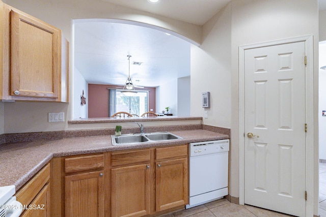 kitchen with arched walkways, light tile patterned floors, stove, white dishwasher, and a sink