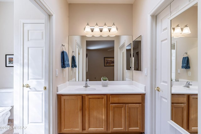 full bathroom with toilet and vanity