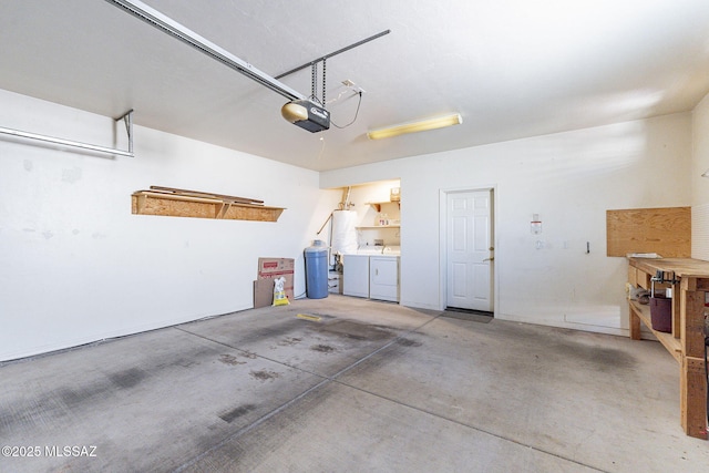 garage with a garage door opener, water heater, and independent washer and dryer