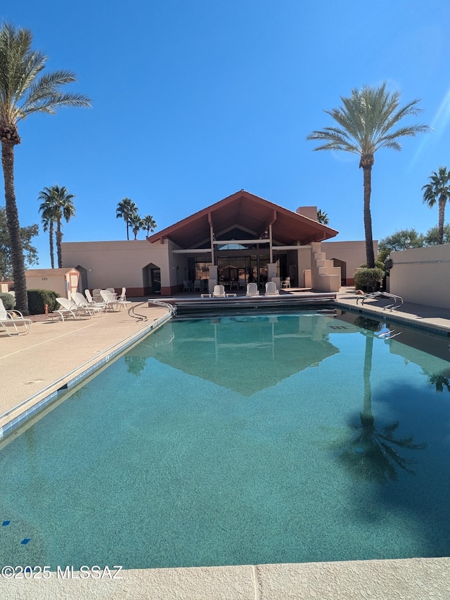 pool featuring a patio area and fence