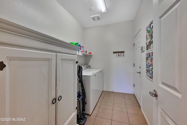 laundry room featuring washing machine and dryer and light tile patterned flooring