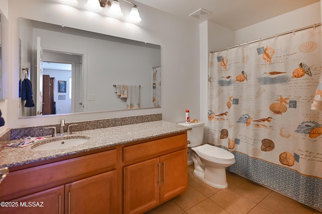 bathroom featuring vanity, curtained shower, tile patterned floors, and toilet