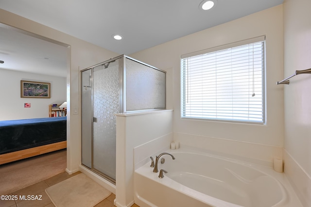 bathroom featuring tile patterned floors and independent shower and bath