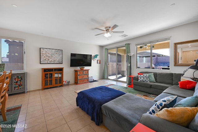 tiled living room featuring ceiling fan