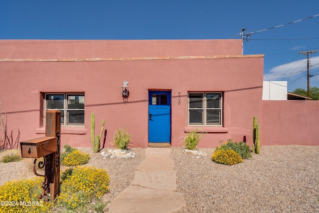 view of front of home featuring fence and stucco siding